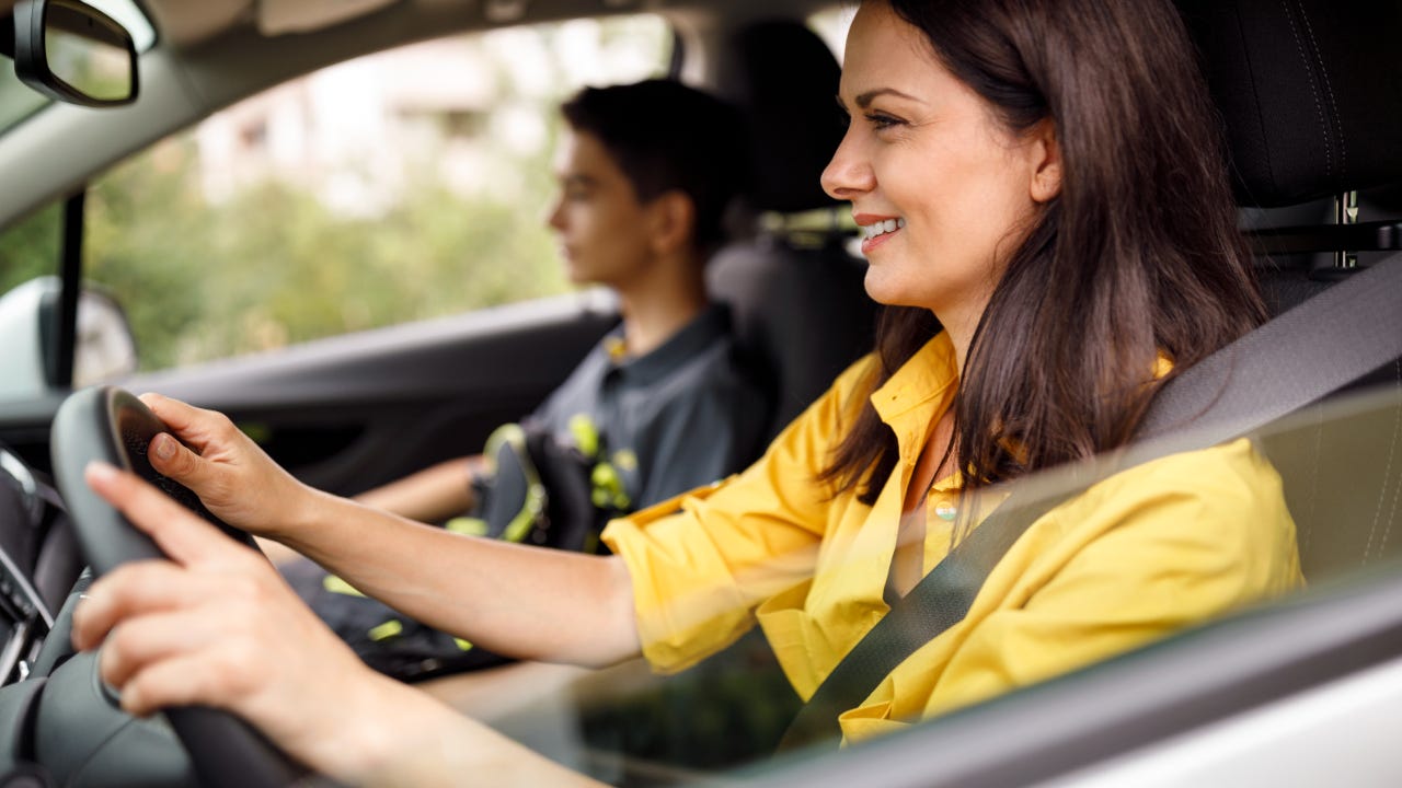 Close up of mother driving teenage son