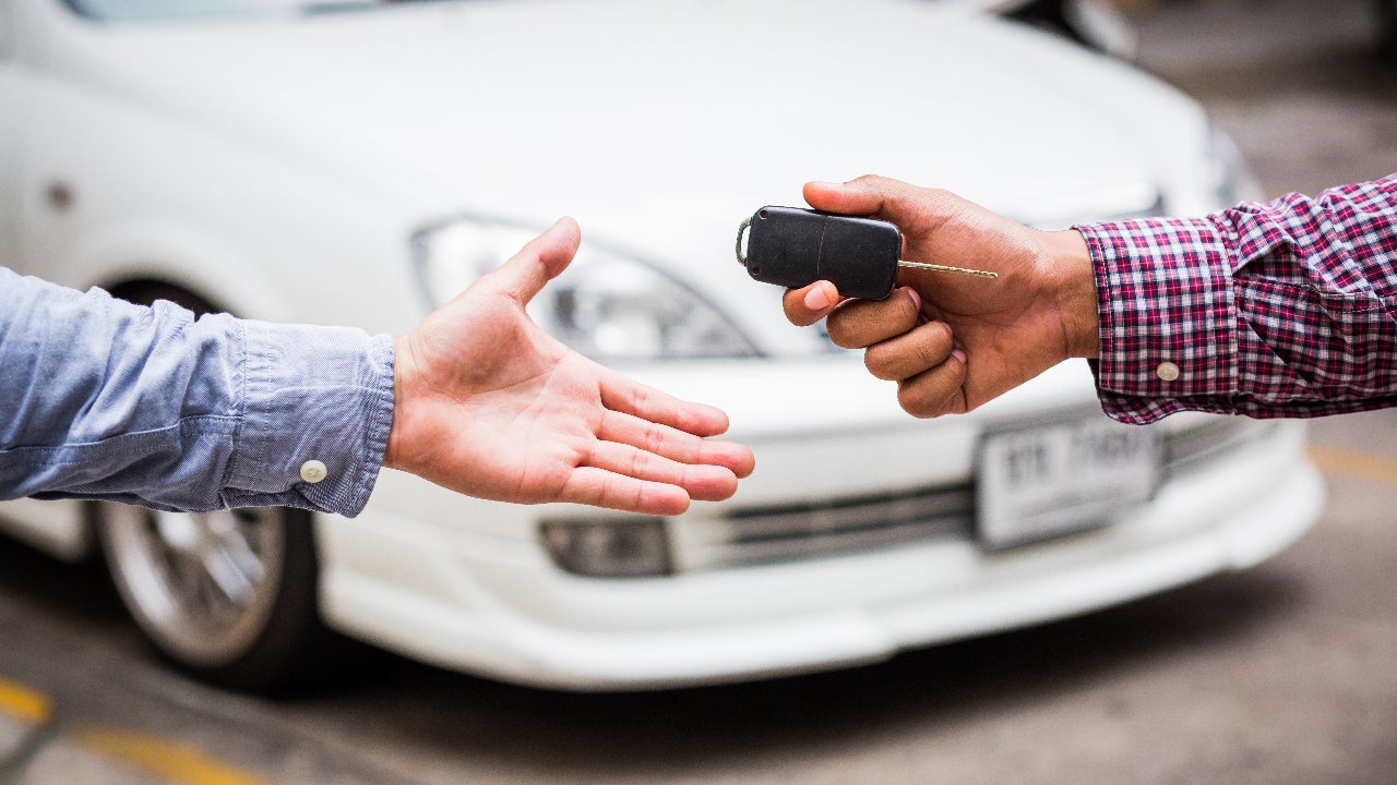 One person hands keys to another.