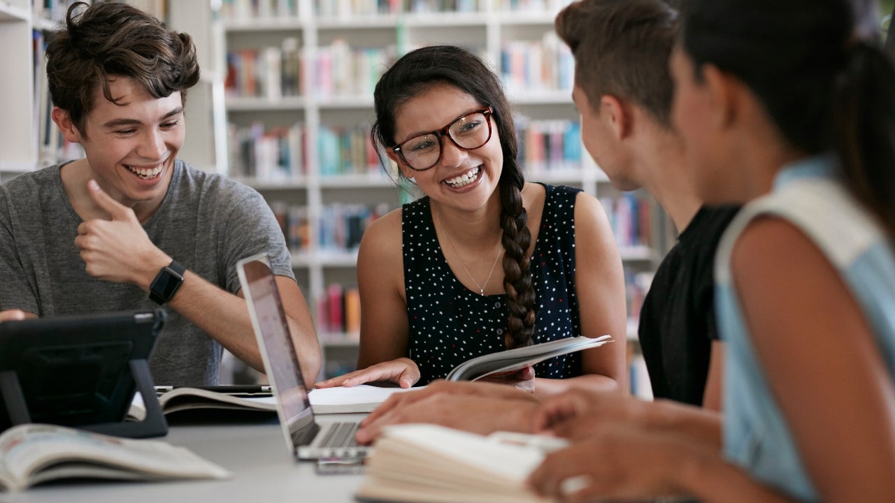 Group of students studies together at the library
