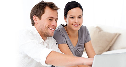 Couple using laptop