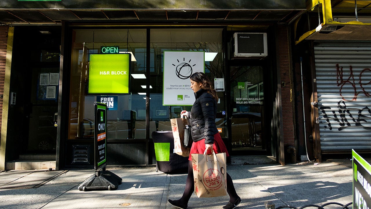 Woman walking past H&R Block