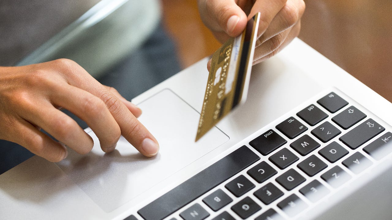 Person on laptop with credit card