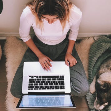 A woman works on her laptop.