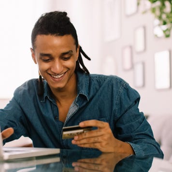 Cheerful young man shopping online
