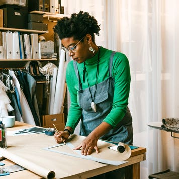 woman working on craft project at a table in her living room