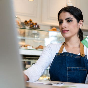 bakery owner making an online purchase with her credit card