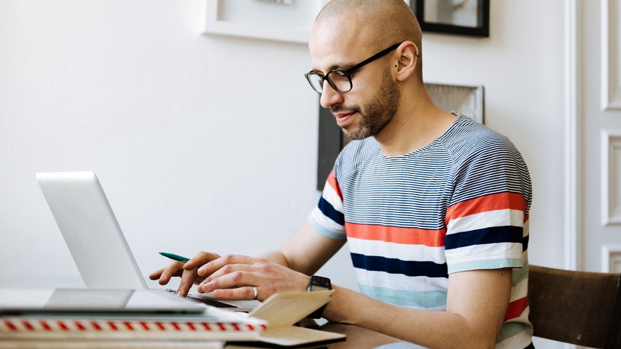 man working on his laptop computer