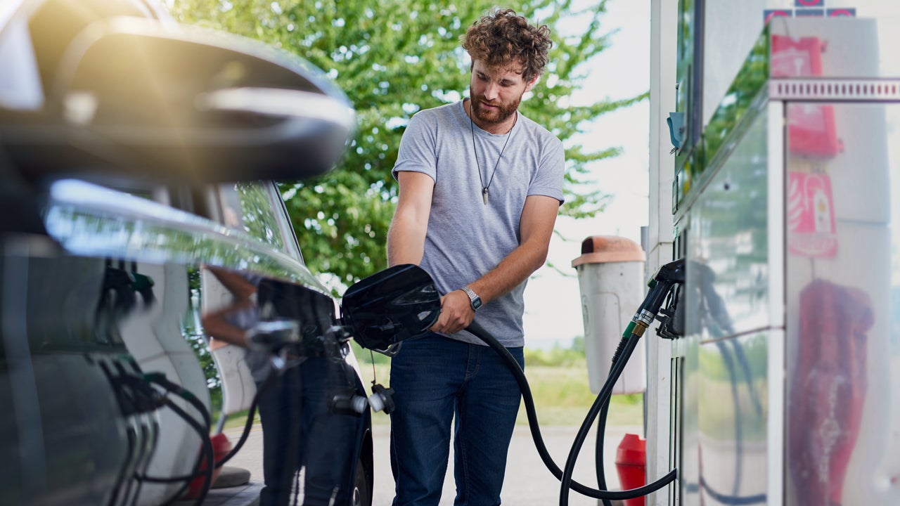 man pumping gas at a gas station