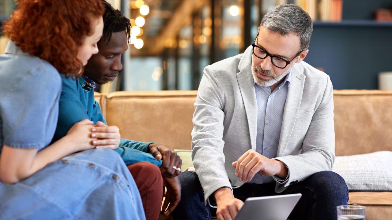 Financial advisor planning with clients at office
