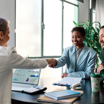 Businesswoman closing a deal with clients