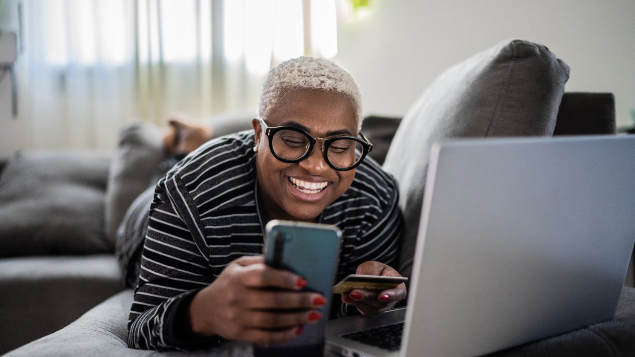 women shopping online using mobile phone at home