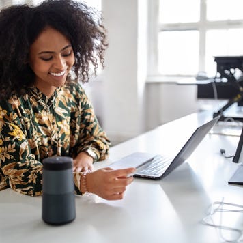 Woman using wireless technology for online shopping