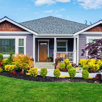 Photo of a modern custom single-level suburban home on a sunny summer day