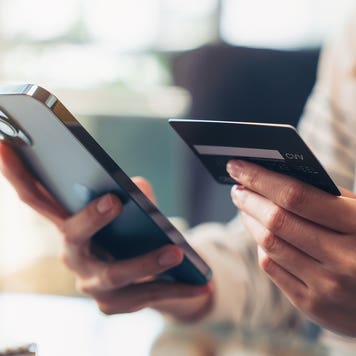 Woman holding credit card and mobile phone
