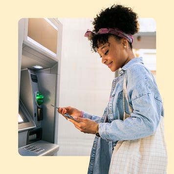 Woman standing in front of an ATM