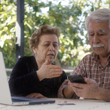 Senior couple having problem with fraud while online shopping with credit cart using laptop computer