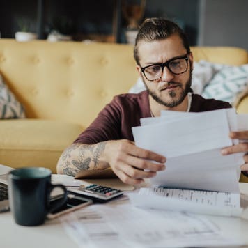 A man looks frustrated while reviewing expenses