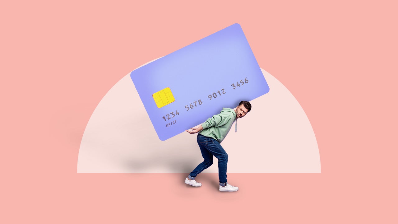 Man being weighed down with a credit card on his back.