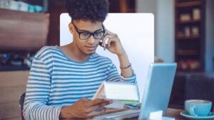 homeowner in striped sweater looking over financial paperwork