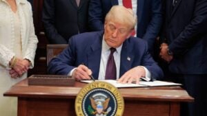 Donald Trump signs an executive order.