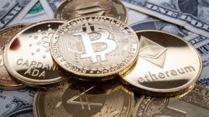 Various cryptocurrency tokens on top of U.S. currency.
