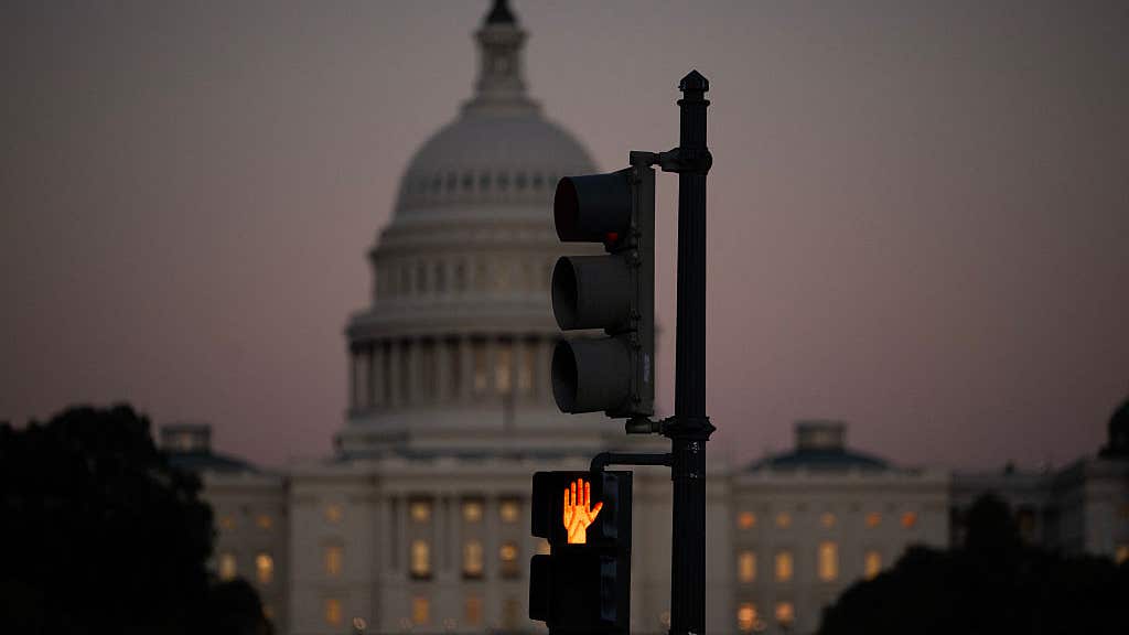 A crosswalk signal of a traffic light flashes backdropped by the US Capitol in Washington, DC, on October 1, 2025, the first day of the US federal government shutdown. Efforts to bring a quick end to the US government shutdown floundered Wednesday when senators rejected a plan to resolve an acrimonious funding stand-off between President Donald Trump and Democrats in Congress. With the government out of money after Trump and lawmakers failed to agree on a deal to keep the lights on, many federal departments and agencies have been closed since midnight.