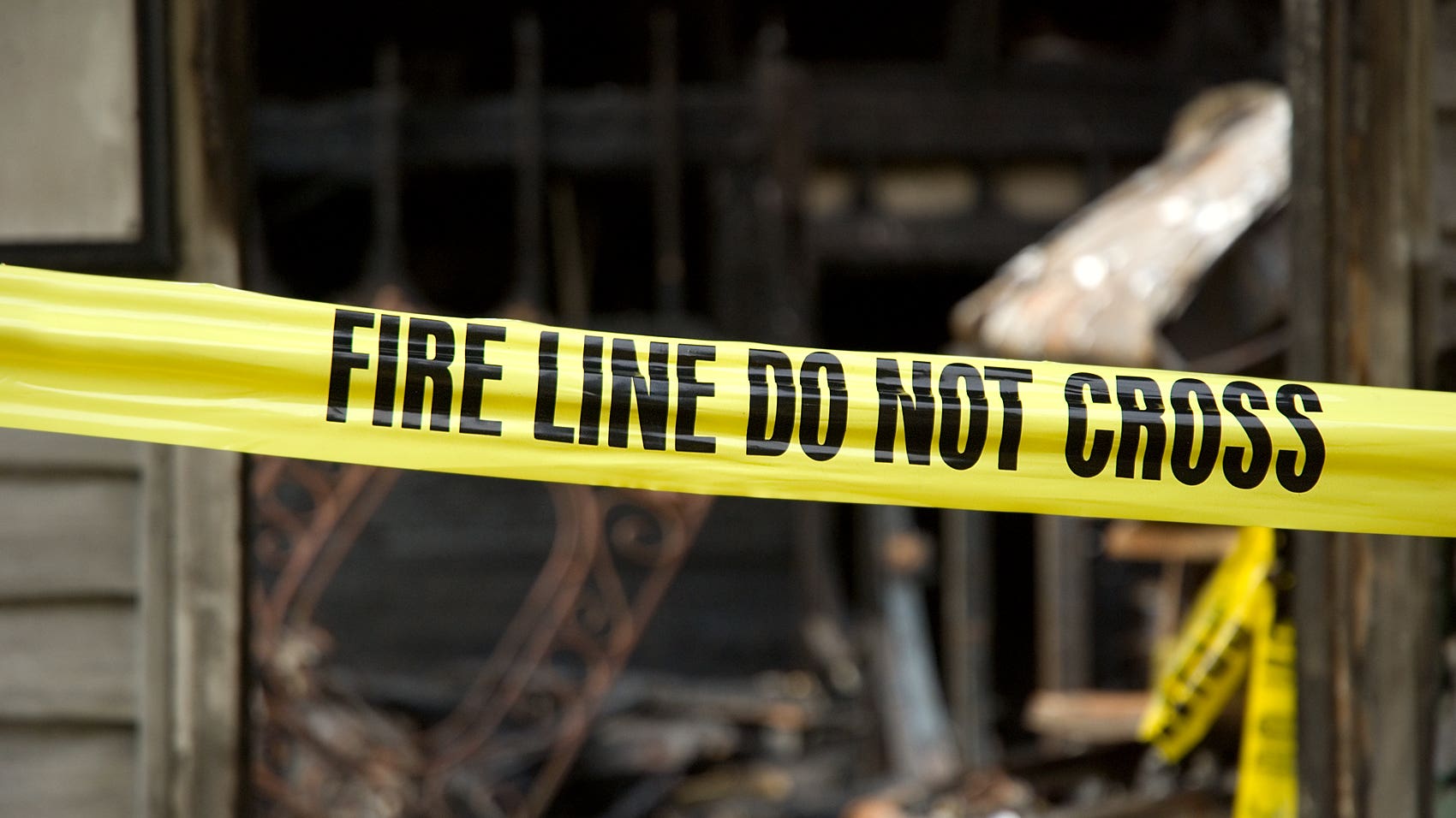 Fire line in front of a destroyed home.
