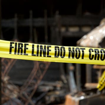 Fire line in front of a destroyed home.