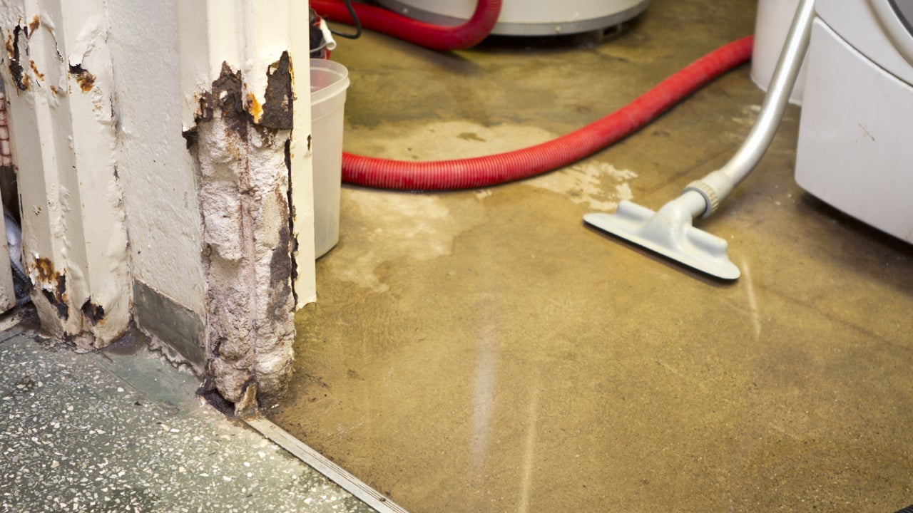 a vacuum on a floor covered in water
