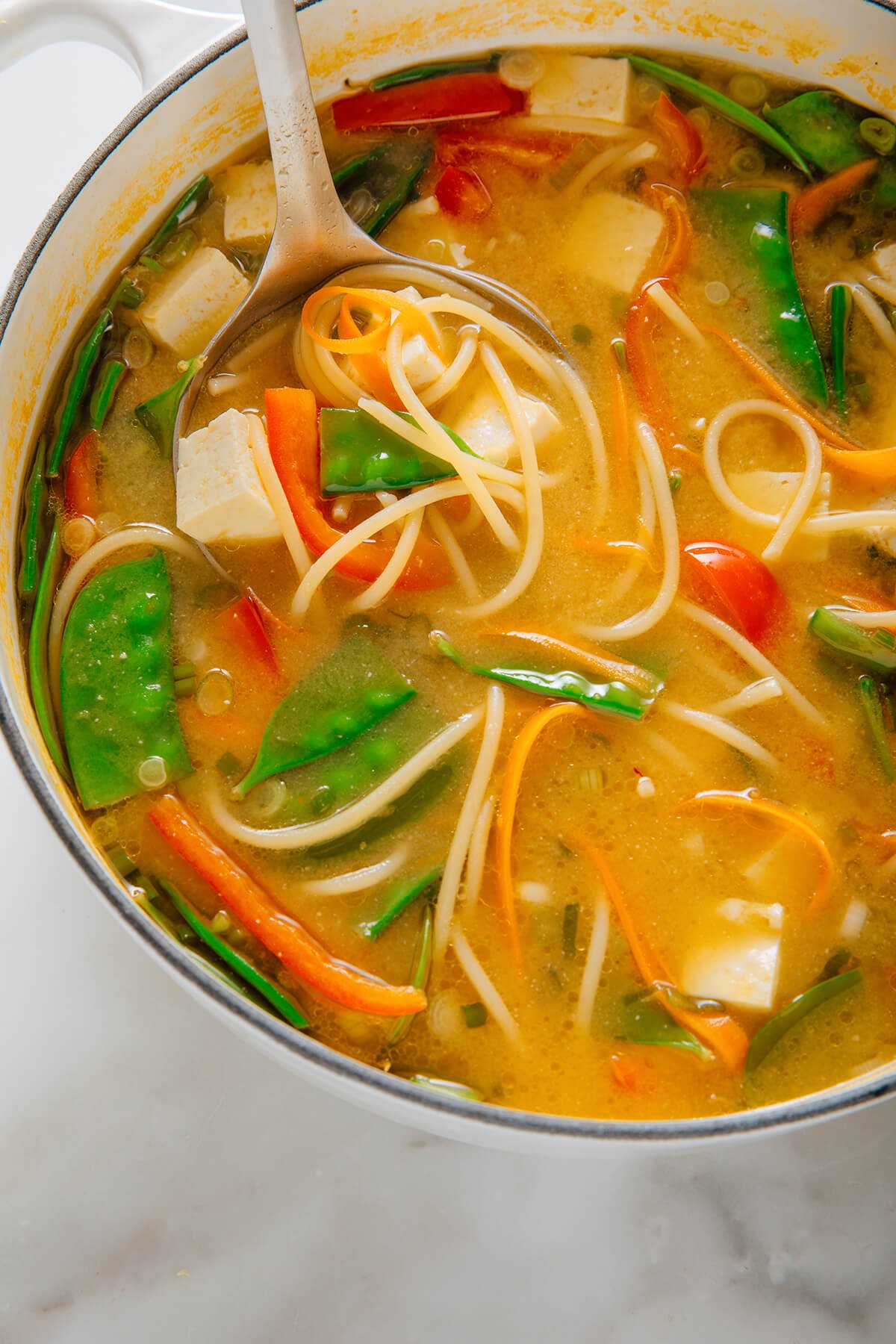 ladle of miso noodle soup