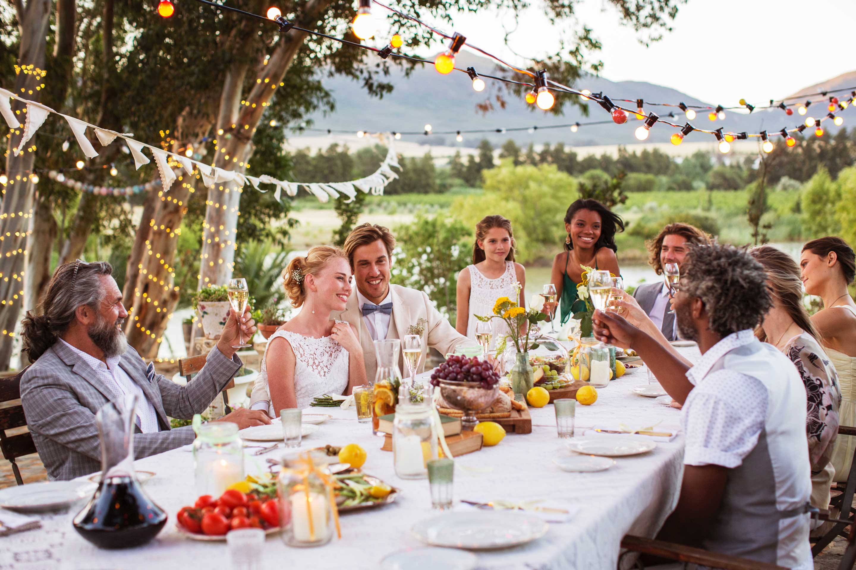 A group of friends sitting down to celebrate their friends wedding.